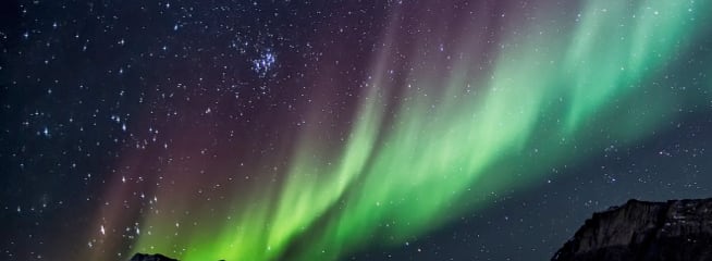 Aurora borealis over mountain tops